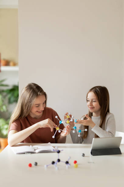 istock Two Schoolgirls Studying Chemistry Together 1190172443