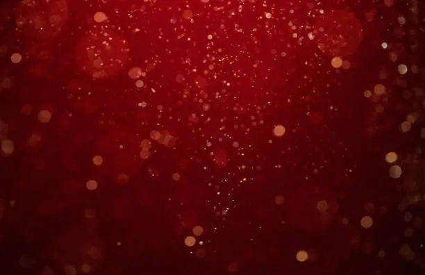 Abstract, defocused red, gold glittering christmas background with copy space