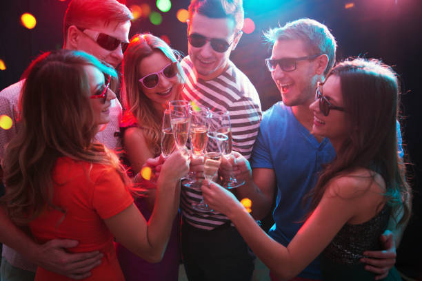 istock Young friends touching the glasses with each other 1190175168