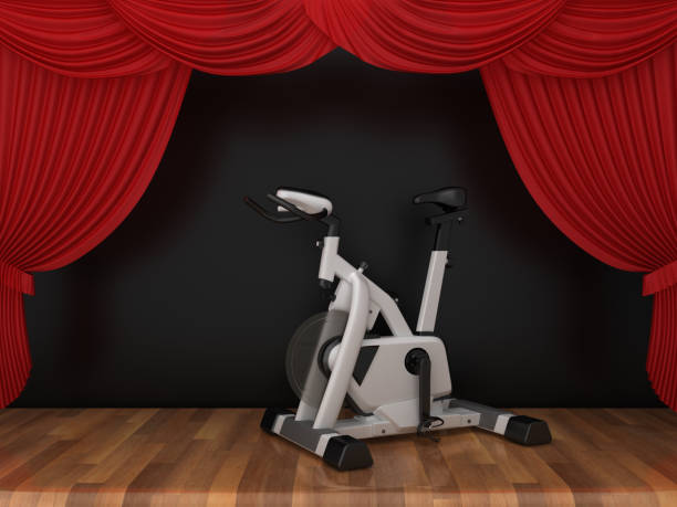 istock Exercise Bike with Red Stage Curtains on Wood Floor - 3D Rendering 1190176843