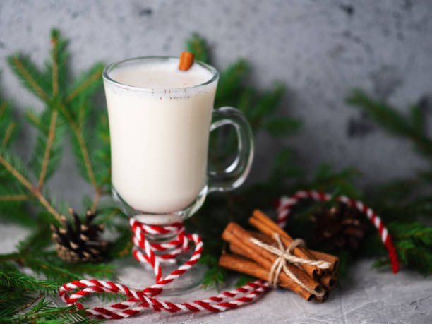 istock Christmas drink egg nog on wooden table with tree branches 1190177006