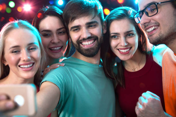 istock Group of happy friends taking selfie 1190179975