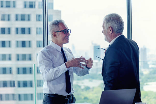 istock Executive business teamwork meeting and present start up new project.  People senior partners discussing graph of financial for investment in modern office.  City background.   Business and Teamwork Concept 1190180033