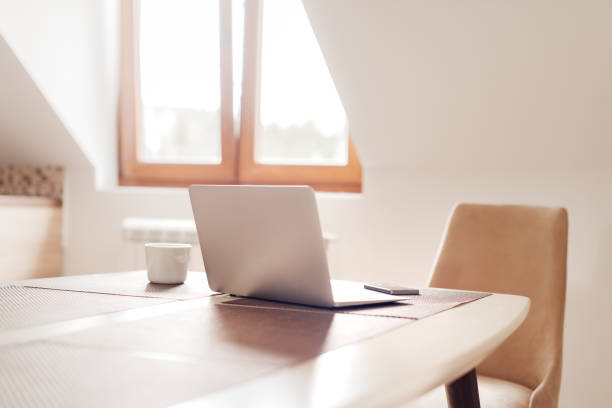 istock Telecommuting workspace with laptop and smartphone 1190180787