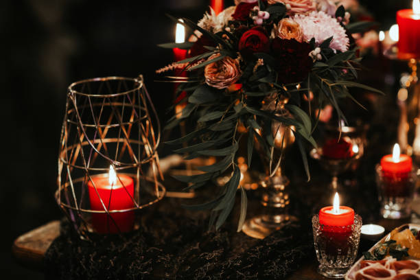 istock Beautiful, decorated table with flower decorations and red candles. Christmas evening or wedding party decoration. 1190180897