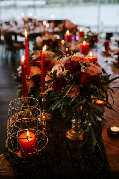 istock Beautiful, decorated table with flower decorations and red candles. Christmas evening or wedding party decoration. 1190180980