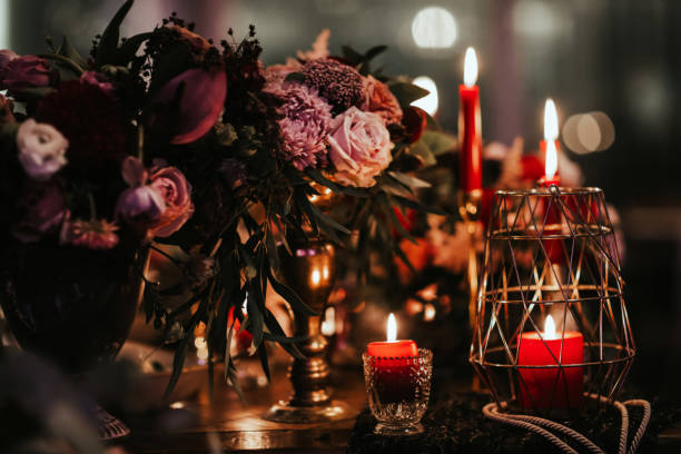 Beautiful, decorated table with flower decorations and red candles. Christmas evening or wedding party decoration. Beautiful, decorated table with flower decorations and red candles. Christmas evening or wedding party decoration. candle light dinner stock pictures, royalty-free photos & images