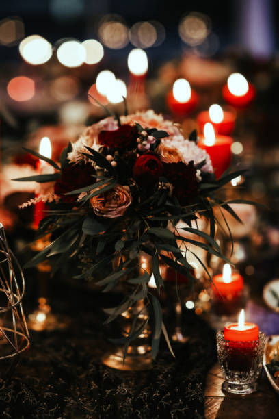 istock Beautiful, decorated table with flower decorations and red candles. Christmas evening or wedding party decoration. 1190181016