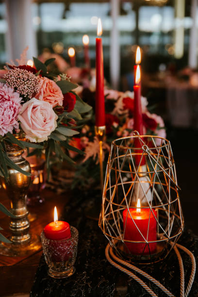 istock Beautiful, decorated table with flower decorations and red candles. Christmas evening or wedding party decoration. 1190181041