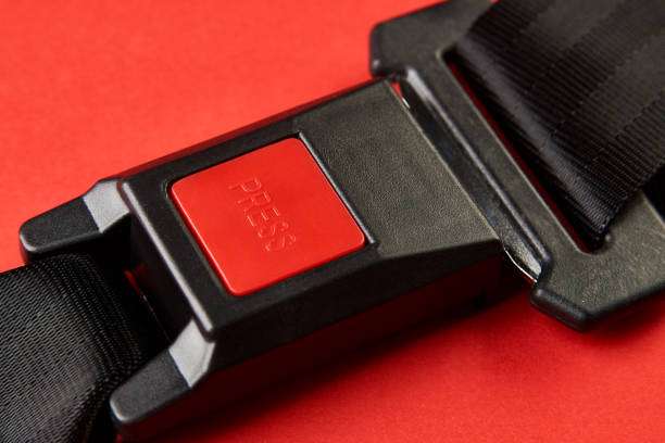 istock Fastened seat belt on red background with copy space, close-up 1190181264