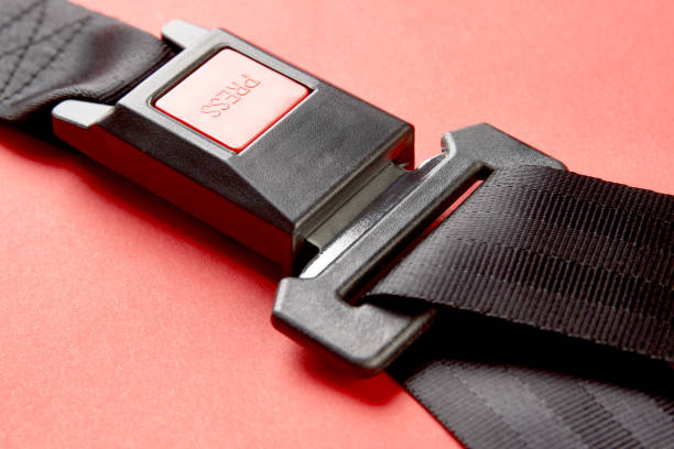 istock Fastened seat belt on red background with copy space, close-up 1190181279