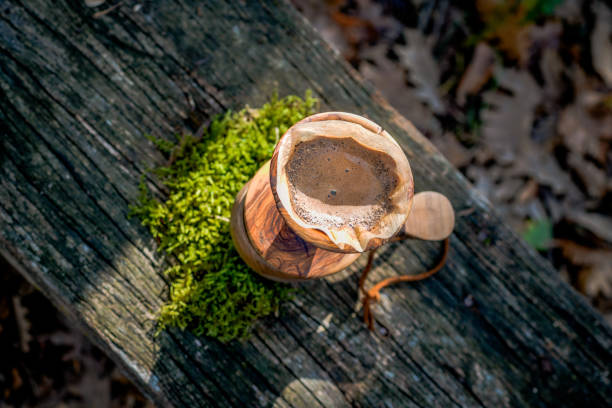 istock Coffee break with drip coffee on the forest, ground coffee on the filter paper and wood dripper 1190181481