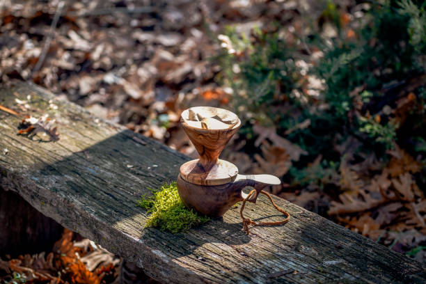 istock Coffee break with drip coffee on the forest, ground coffee on the filter paper and wood dripper 1190181482