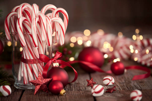 istock Candy Canes and Bright Christmas Lights on an Old Wood Background 1190183317