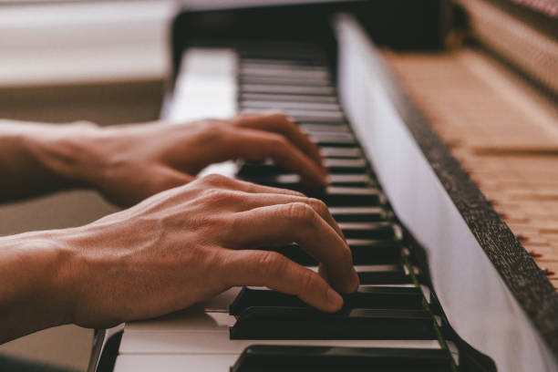 istock The piano keyboard with hands 1190183406