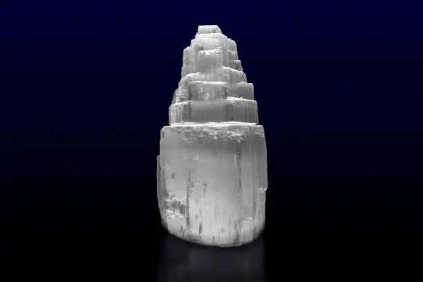 Transparent crystal of Selenite isolated on dark background