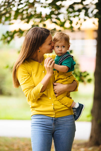 istock Beautiful young mother holding her baby boy 1190184837