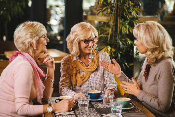 istock Three senior ladies socializing over coffee in cafe 1190185078