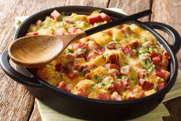istock Strata bread casserole with ham, onions, cheese and eggs close-up in a pan. horizontal 1190187342