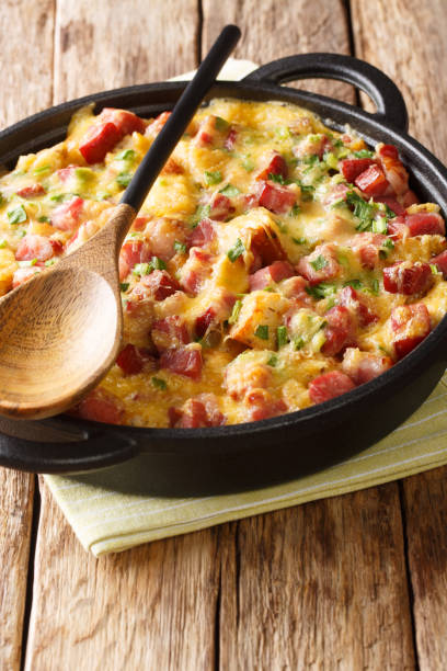 istock Tasty American breakfast strata with ham, bread, onions, cheese and eggs close-up. vertical 1190187979