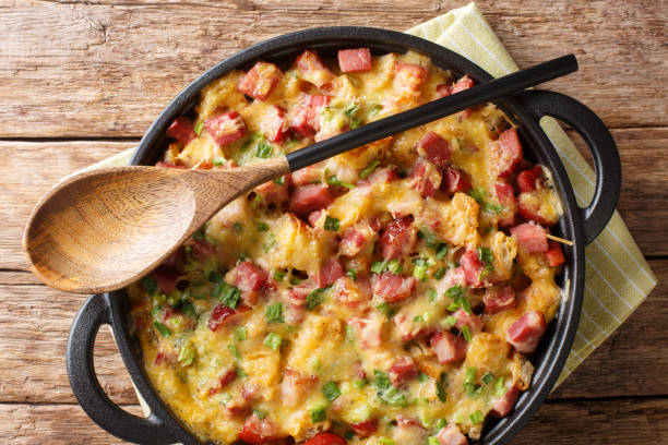 istock Strata bread casserole with ham, onions, cheese and eggs close-up in a pan. Horizontal top view 1190188110