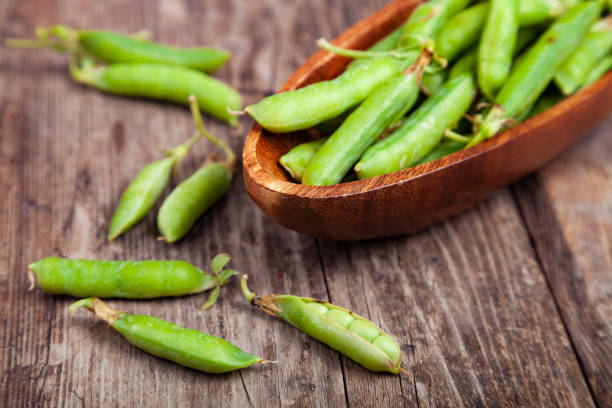 istock Green peas in a wooden bowl. 1190190120
