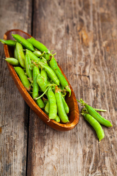 istock Green peas in a wooden bowl. 1190190349