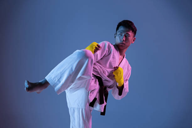 istock Confident korean man in kimono practicing hand-to-hand combat, martial arts 1190192647