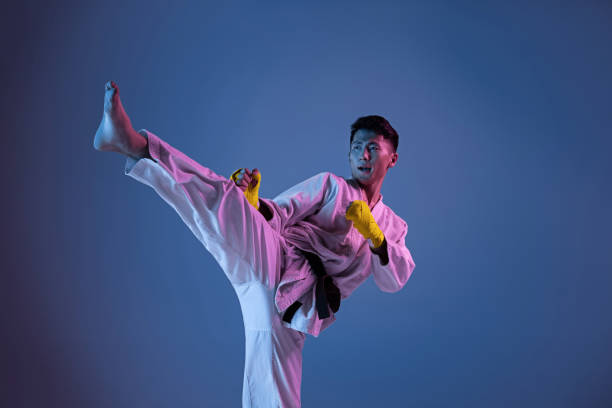 istock Confident korean man in kimono practicing hand-to-hand combat, martial arts 1190192648