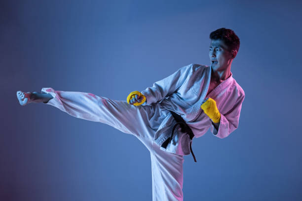 istock Confident korean man in kimono practicing hand-to-hand combat, martial arts 1190192658