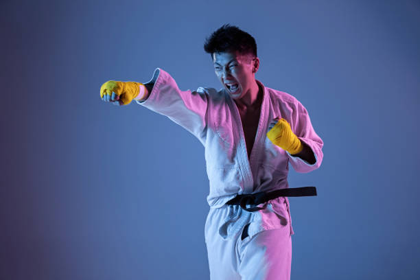 istock Confident korean man in kimono practicing hand-to-hand combat, martial arts 1190192659