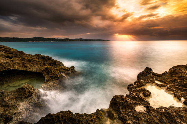 istock Sunset over a tropical rocky beach 1190192874