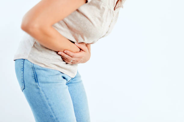 istock Woman with stomach/ hip issues / problems on the white background. 1190193480
