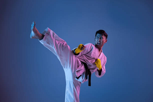istock Confident korean man in kimono practicing hand-to-hand combat, martial arts 1190194969