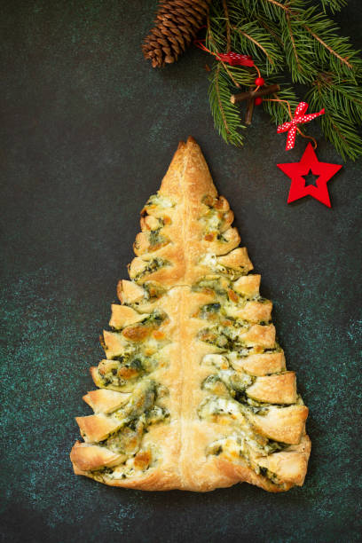 istock Christmas snack menu. Pizza Christmas tree with mozzarella and spinach on a dark tabletop background. Top view of a flat lay. 1190195118