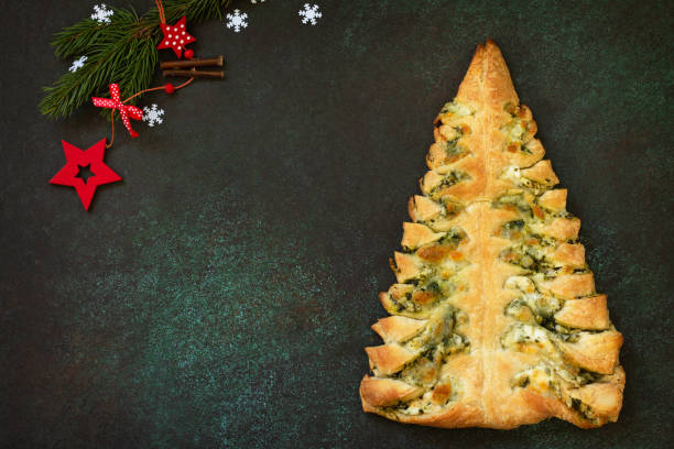 istock Christmas snack menu. Pizza Christmas tree with mozzarella and spinach on a dark tabletop background. Top view of a flat lay with copy space. 1190195137