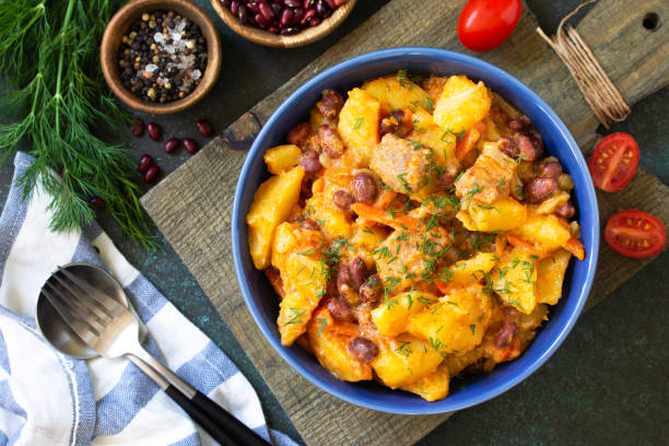 istock Thanksgiving Autumn Menu. Stew with beans and vegetables in a bowl on a rustic table. Top view of a flat lay with copy space. 1190196354