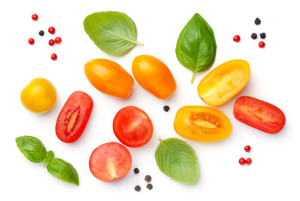Cherry Tomatoes Composition With Basil And Peppercorns Cherry tomatoes composition with basil and peppercorns isolated on white background. Red and yellow tomato. Top view, flat lay cherry tomato stock pictures, royalty-free photos & images