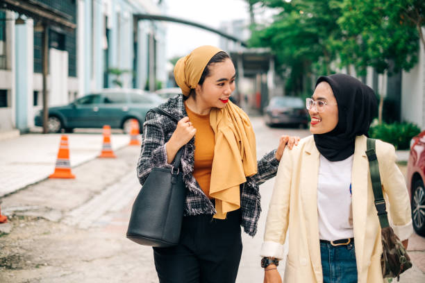 istock Two Businesswomen Discussing While Walking 1190198585