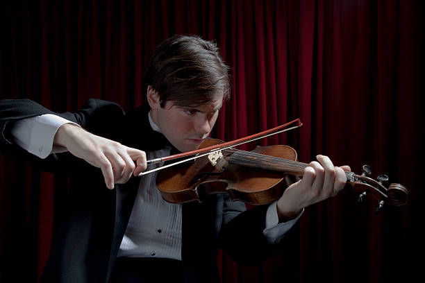 istock Young man in tuxedo playing violin 119020130