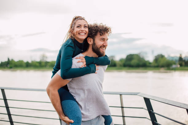 istock Man holding his girlfriend on the back 1190203160
