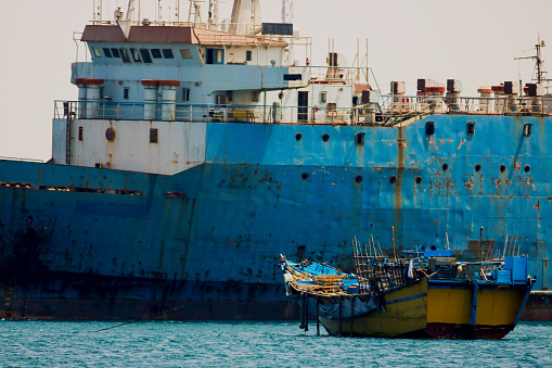Ship wrecks in the port of Bossaso Somalia and a small trading ship the same are used as a motherboat for piracy