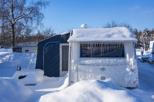 Snowy and icy caravan at a campsite