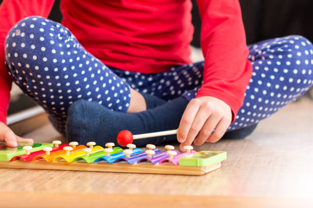 istock Girl playing xylophone, close up. 1190204672