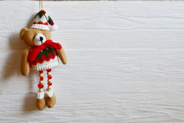 istock Christmas toy bear on a white wood background. 1190204711