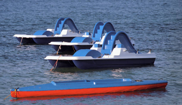 istock three pedal boats floating on water 1190204746