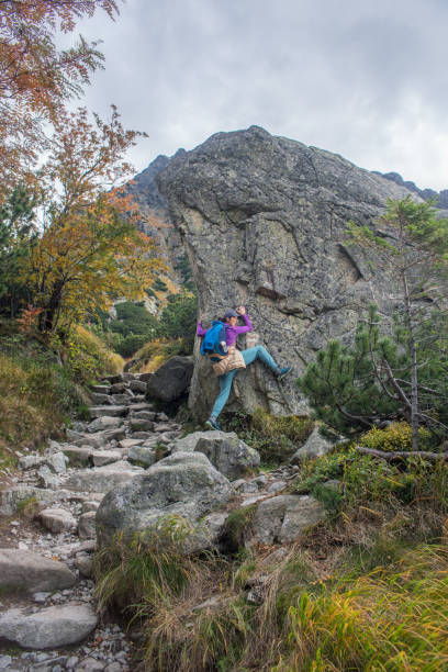Woman climbing a small rock