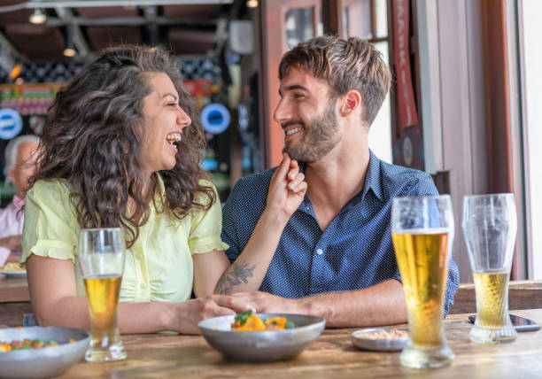 istock Young couple flirting at pub drinking beer 1190204995