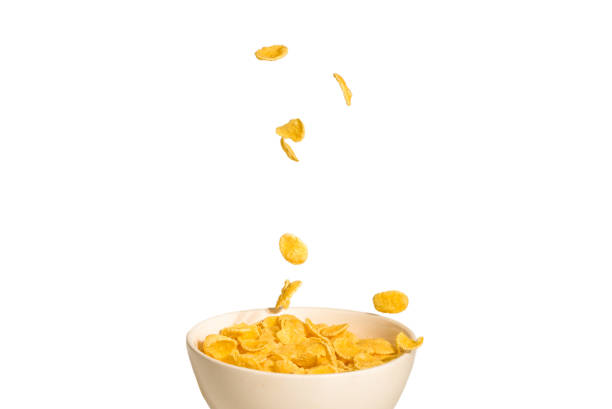 istock Corn flakes falling to the white bowl. Motion. 1190205485