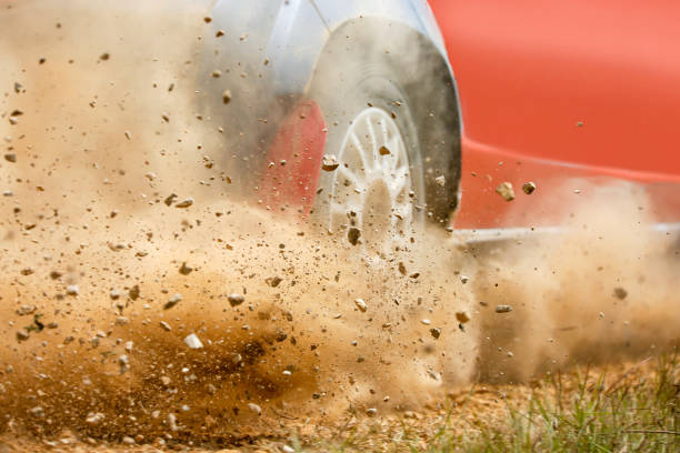gravel splashing from rally race car drift on track. - motor racing track motorized sport sports race road imagens e fotografias de stock